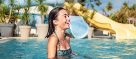 Smiling girl in pools at Les Embruns